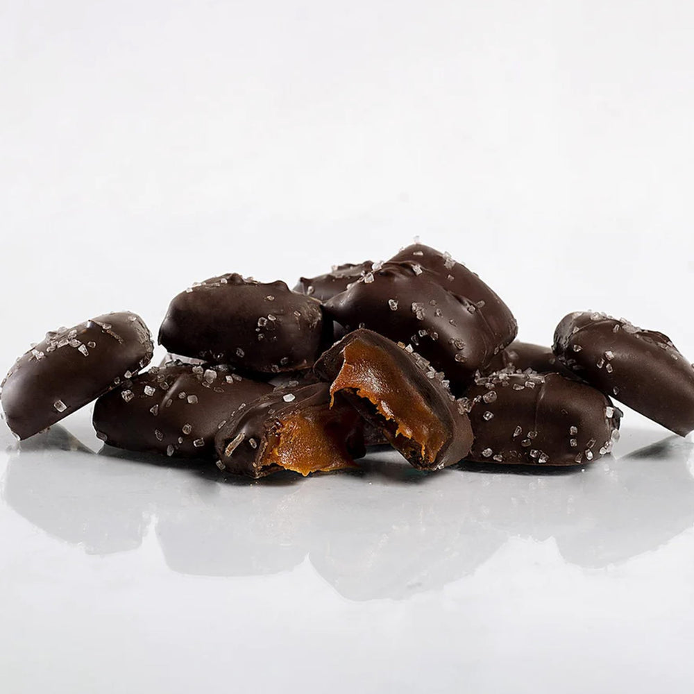 Close-up of Sanders Dark Chocolate Sea Salt Caramel Minis, glossy coating and salt crystals, great snack.