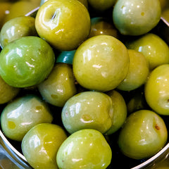 Closeup of Sanniti Castelvetrano olives highlighting fleshy interior.