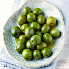 Sanniti Castelvetrano olives in a bowl showing plump, fleshy texture.