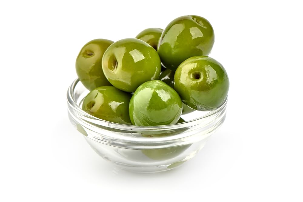 Sanniti Castelvetrano olives on the counter beside fresh bread.