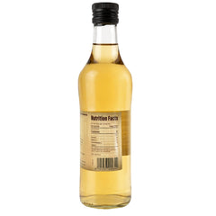 Pouring Sanniti Champagne Ardenne Vinegar to brighten a dish with a subtle tang.
