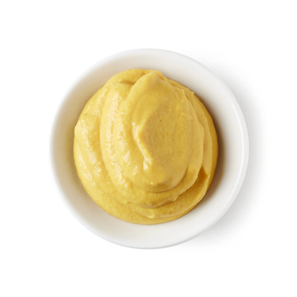 Sanniti Dijon Mustard on baguette slice for sandwich inspiration.
