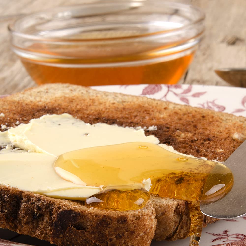 Sanniti Fulmer Acacia honey on a cheese board for gourmet pairing.