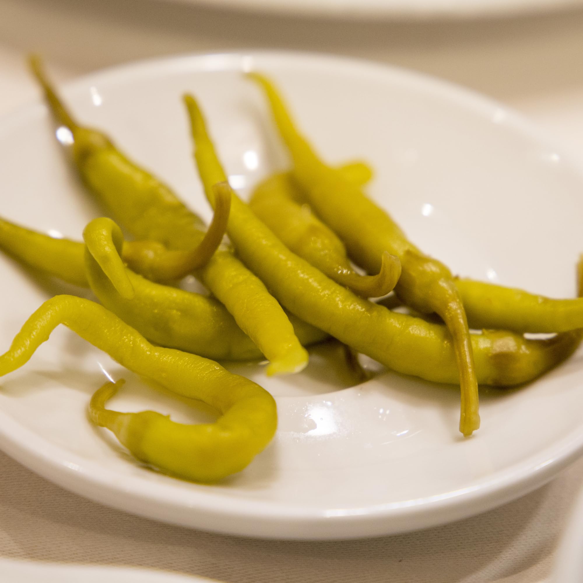 Sanniti Guindillas Piparras on charcuterie plate, vibrant color and tang.