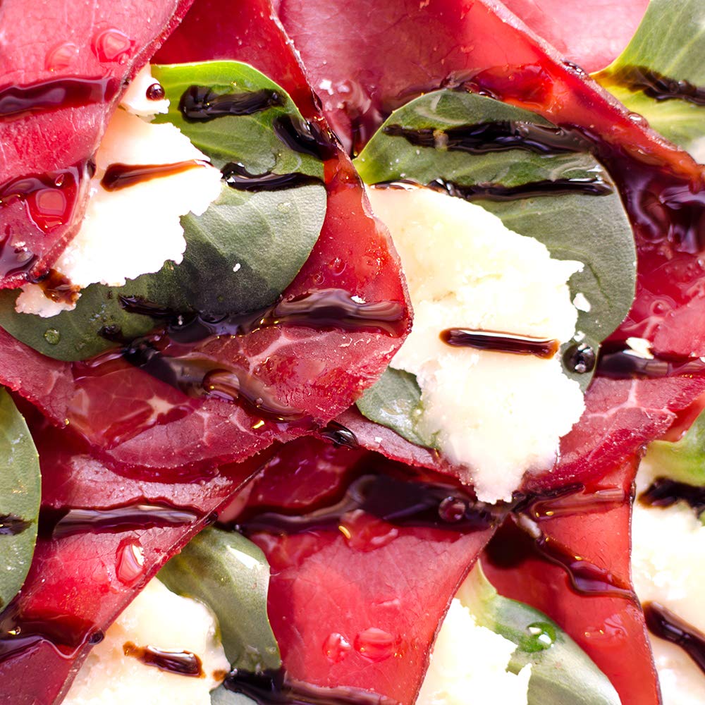 Sanniti Saba being poured over fresh fruit for a bright finish