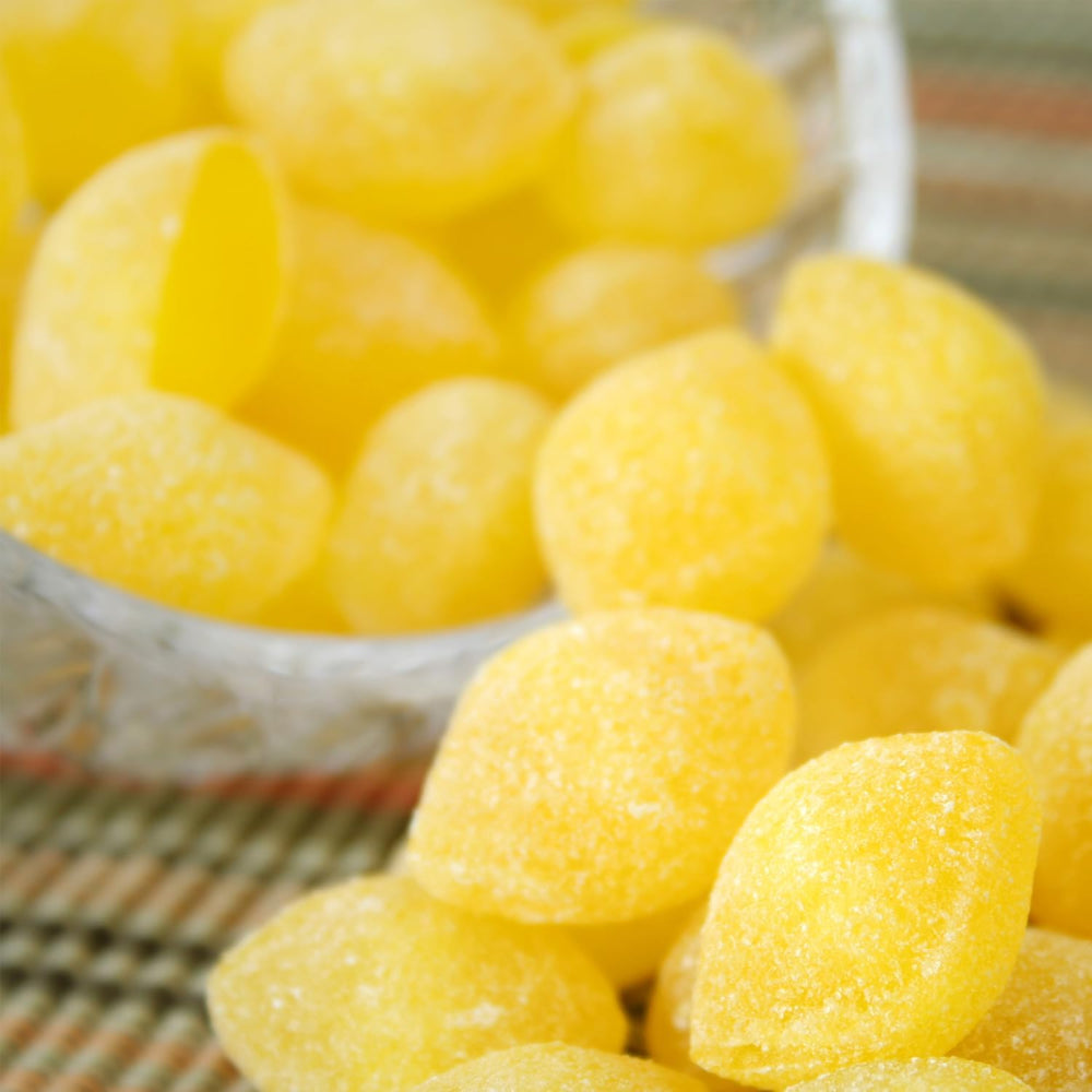 Sarah's Candy Factory sanded lemon drops in bulk jar, spoon-ready for desk snacking.