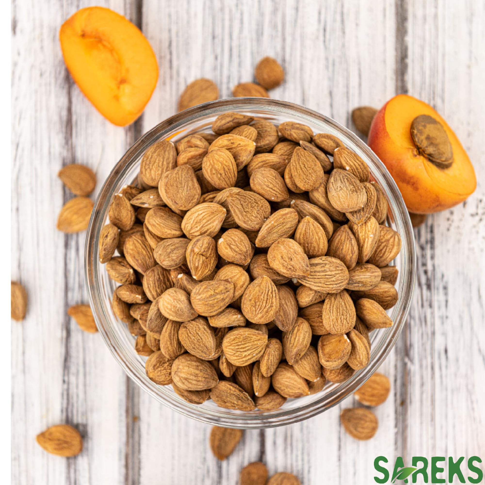 SAREKS bitter apricot kernels on a measuring spoon for precise portions.