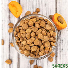 SAREKS bitter apricot kernels on a measuring spoon for precise portions.