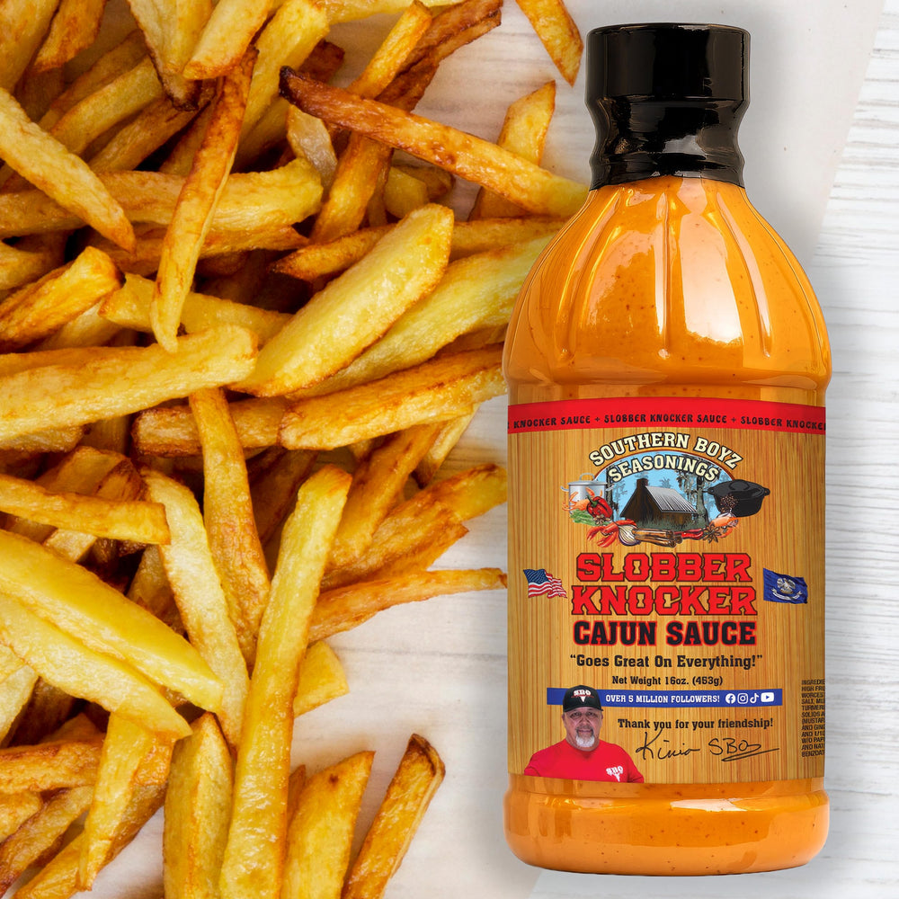 Grilled meats finished with Slobber Knocker Cajun sauce for a zesty glaze.