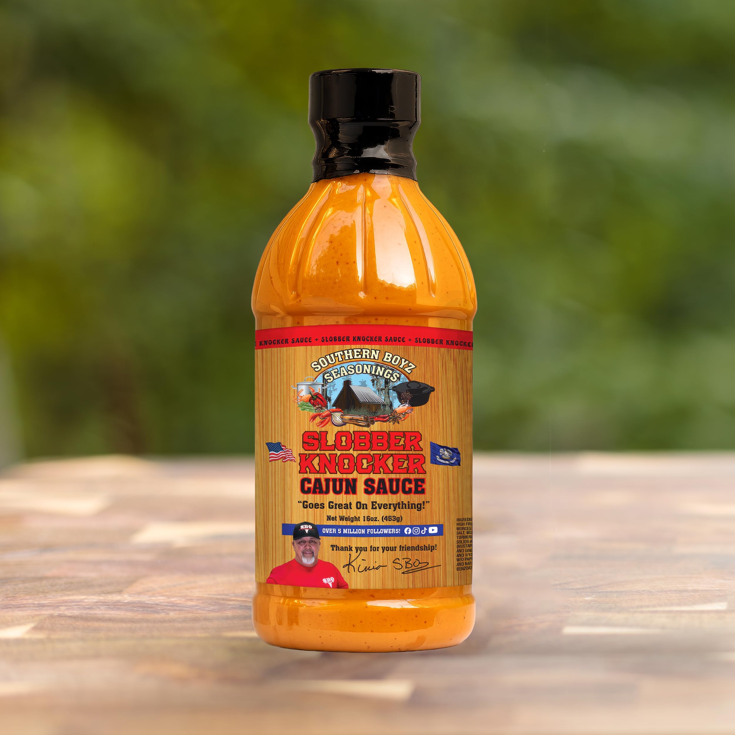 Label of Slobber Knocker Cajun sauce from SBO brand for authentic Louisiana style.