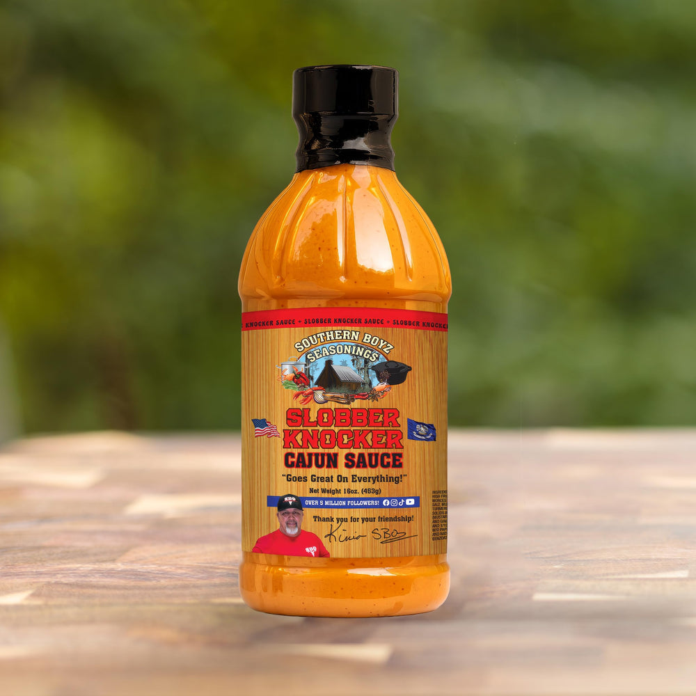 Label of Slobber Knocker Cajun sauce from SBO brand for authentic Louisiana style.