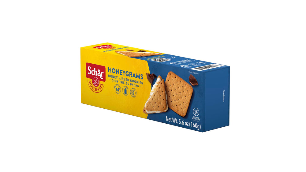 Schär Honeygram Crackers on a campfire setup outdoors.