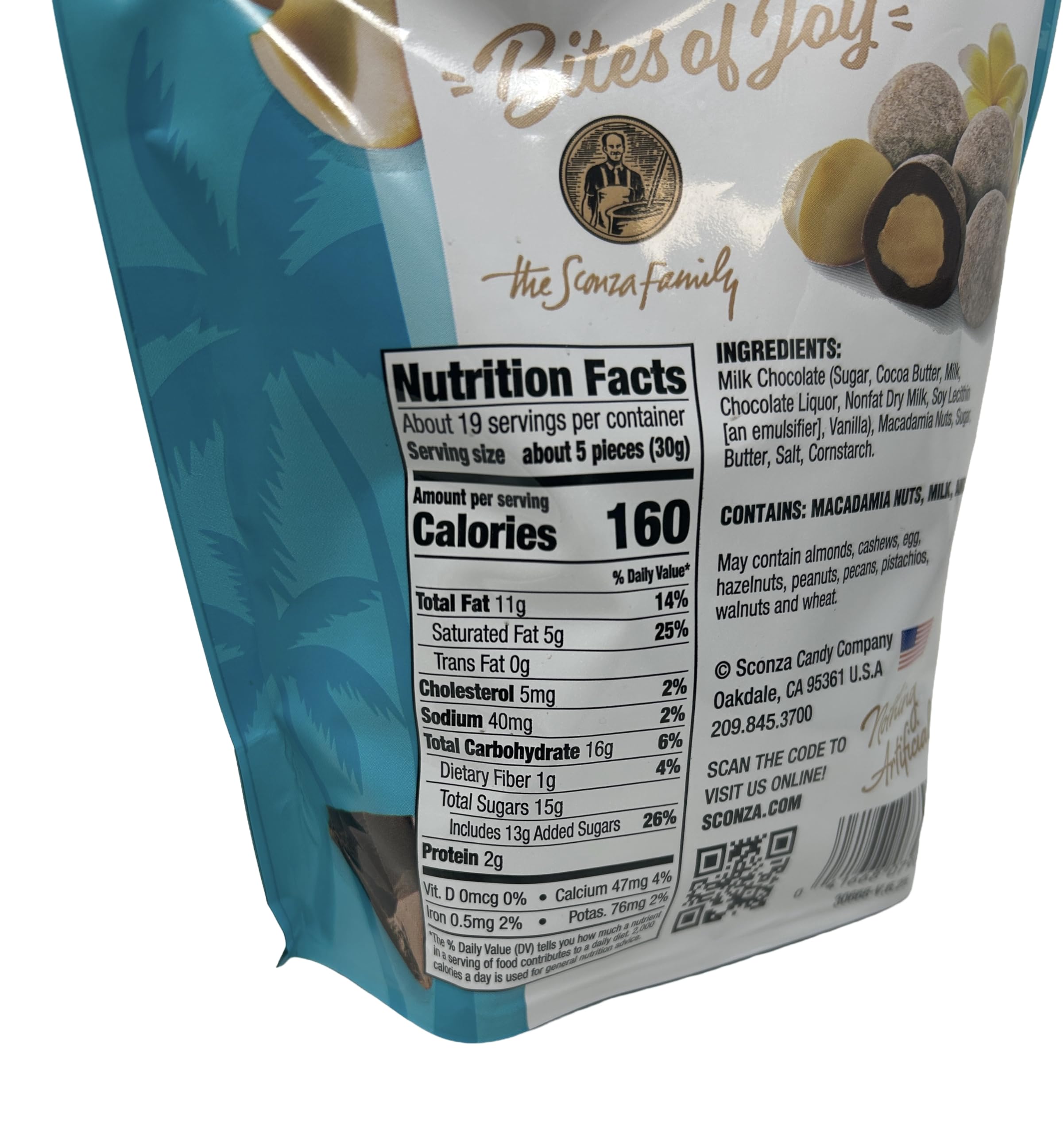 Sconza Crunchy Toffee Milk Chocolate Macadamias dusted with powdered sugar, ready to enjoy.