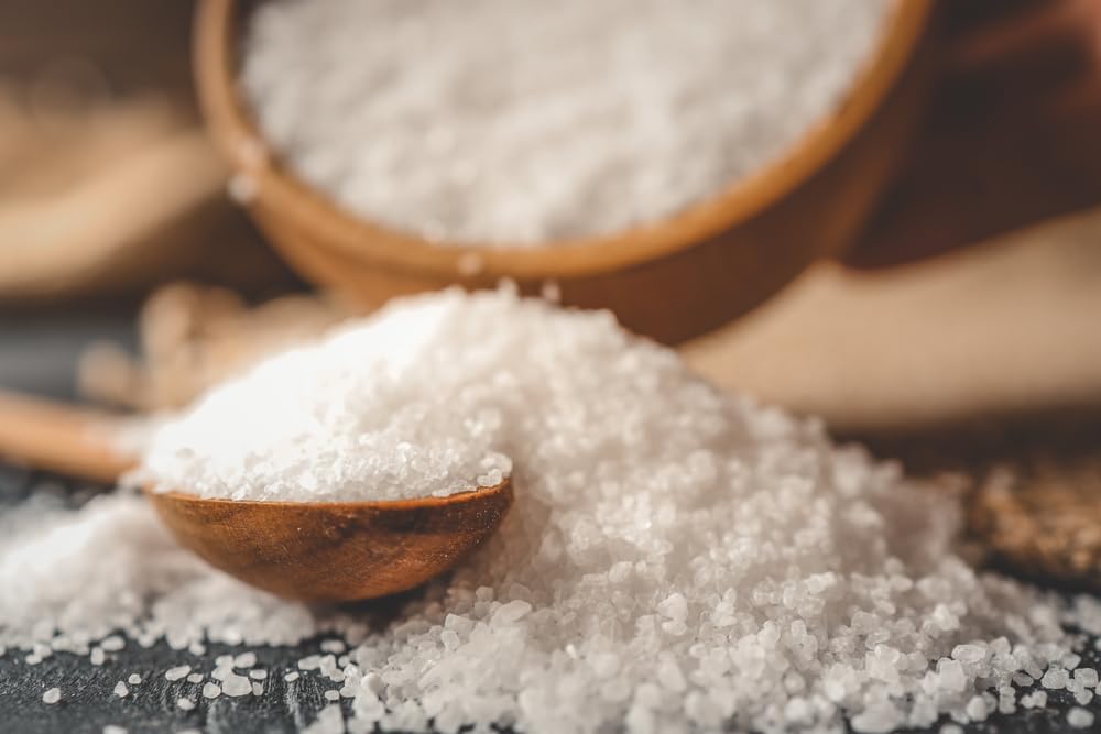 Seasonello coarse salt poured from a shaker into a pan for roasting