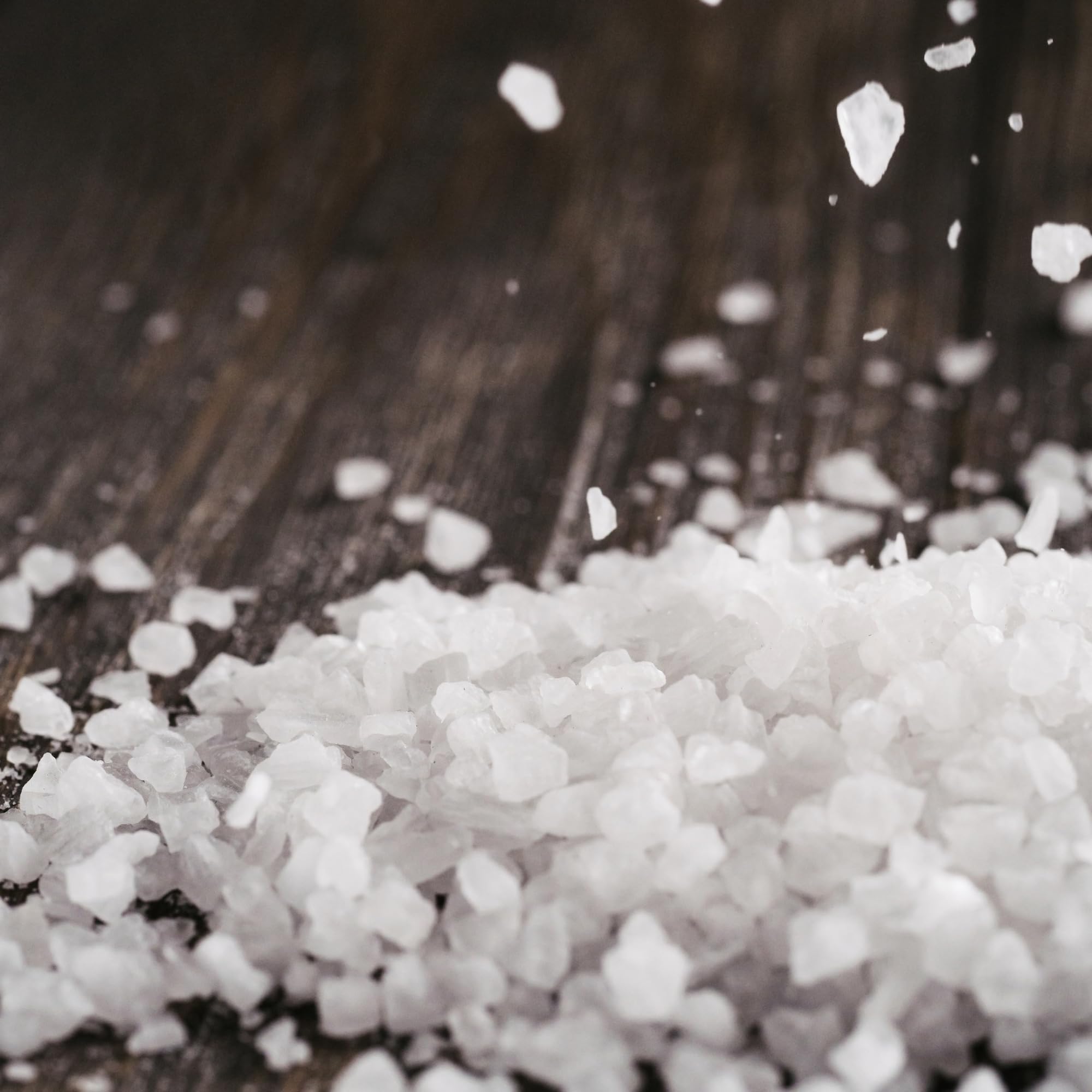 Seasonello coarse salt being used to season food at the stove