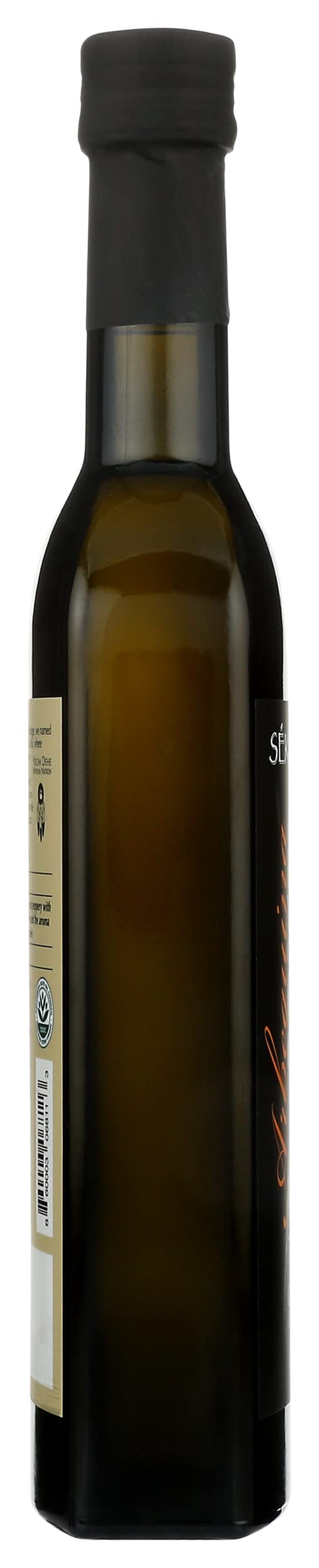 Seka Hills Estate Arbequina EVOO glass bottle on countertop suggests everyday versatility in home cooking.
