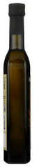 Seka Hills Estate Arbequina EVOO glass bottle on countertop suggests everyday versatility in home cooking.