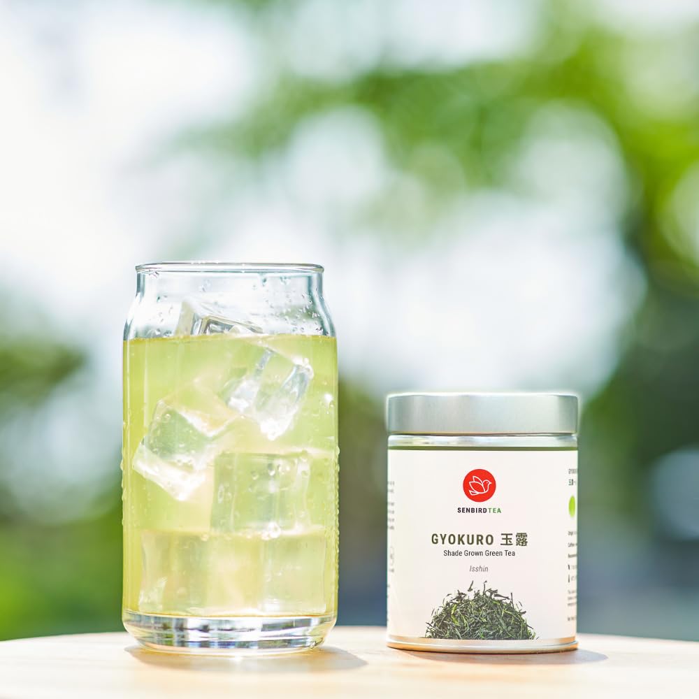 Senbird Gyokuro pale gold brew in glass cup.