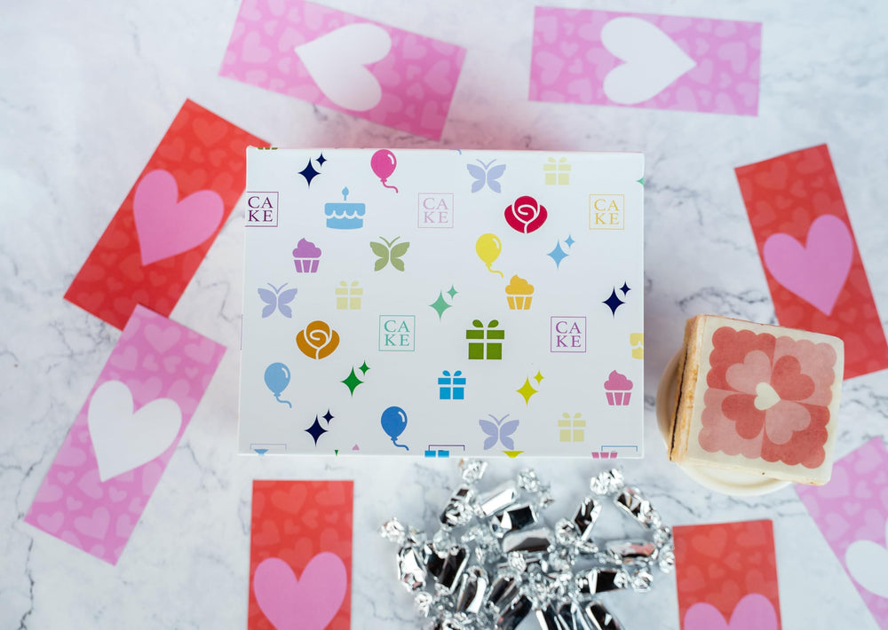 Heart confetti close-up highlights celebratory mood in the Roses & Charms box.
