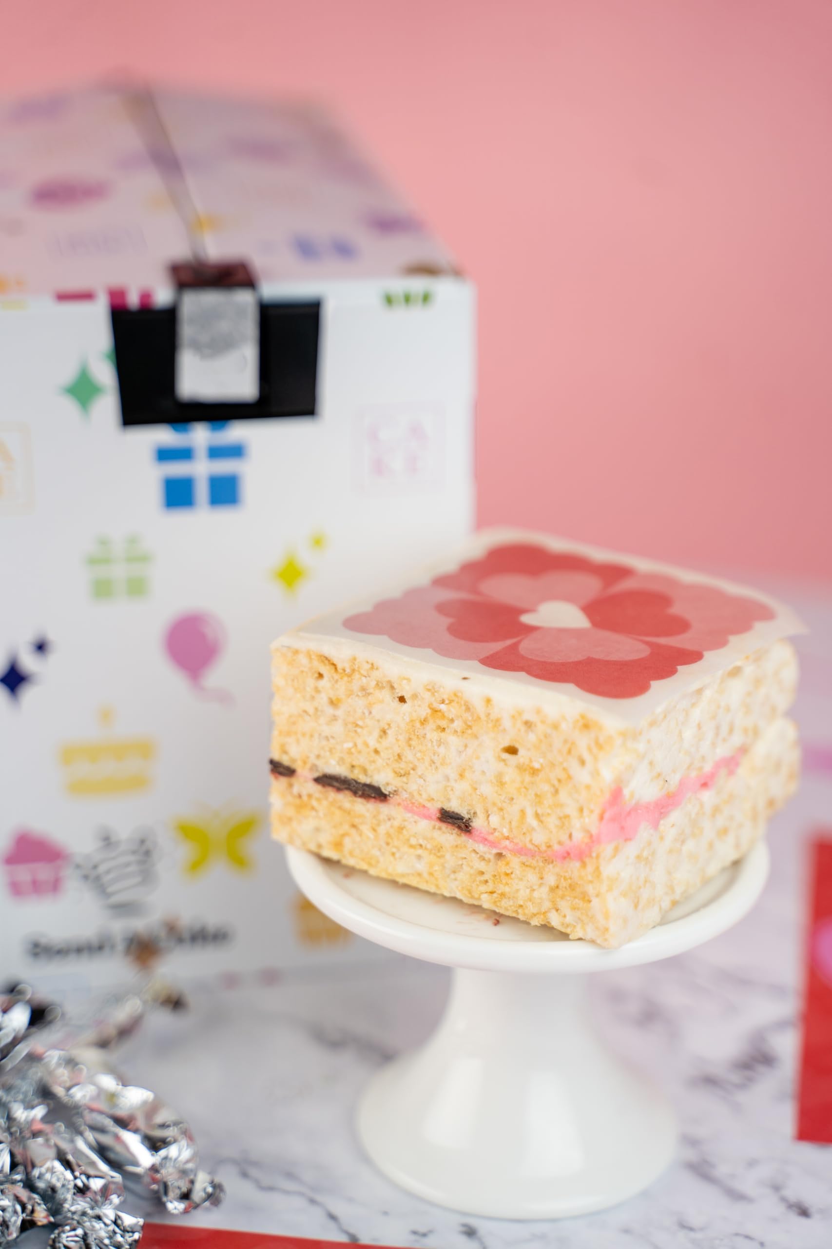 Inside the Send A Cake Roses & Charms gift box reveals treats and keepsakes.