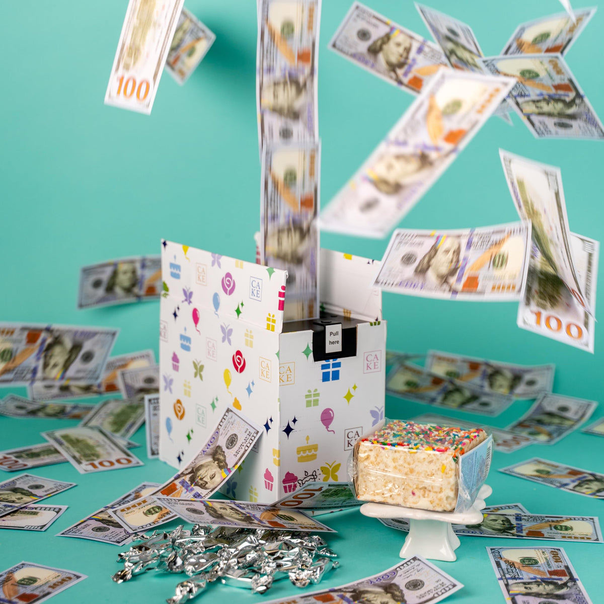 Send A Cake Celebration Billionaire Box with festive packaging and music sets a celebratory mood.