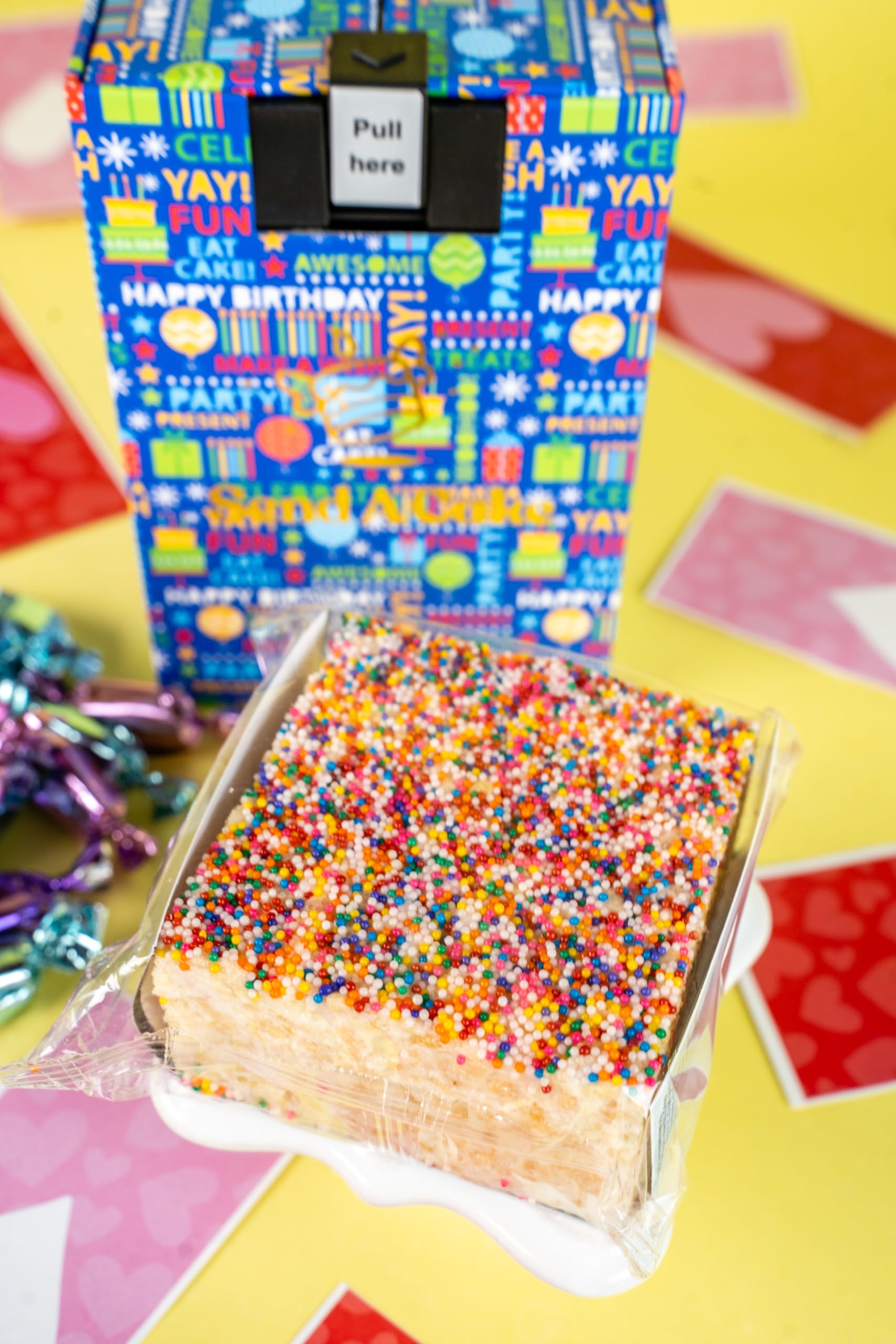 Rainbow Sprinkle Dots Cake with marshmallowy texture and a candle.