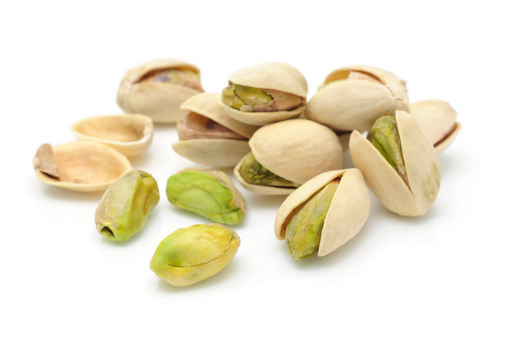 Pistachios being poured into a bowl for gatherings.