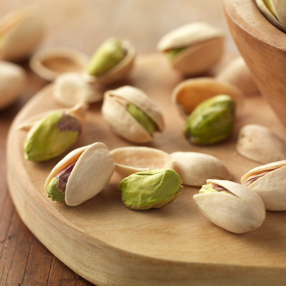 Setton Farms pistachios in shell closeup, vibrant kernels ready to eat.