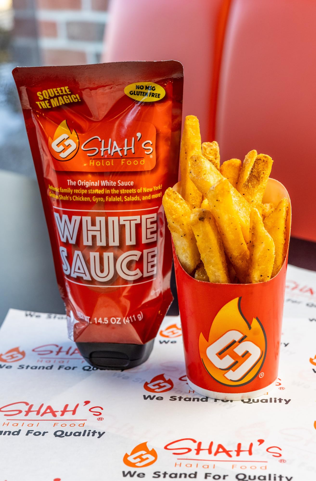 SHAH'S HALAL FOOD White Sauce on kebabs, enhancing spices with a smooth finish.