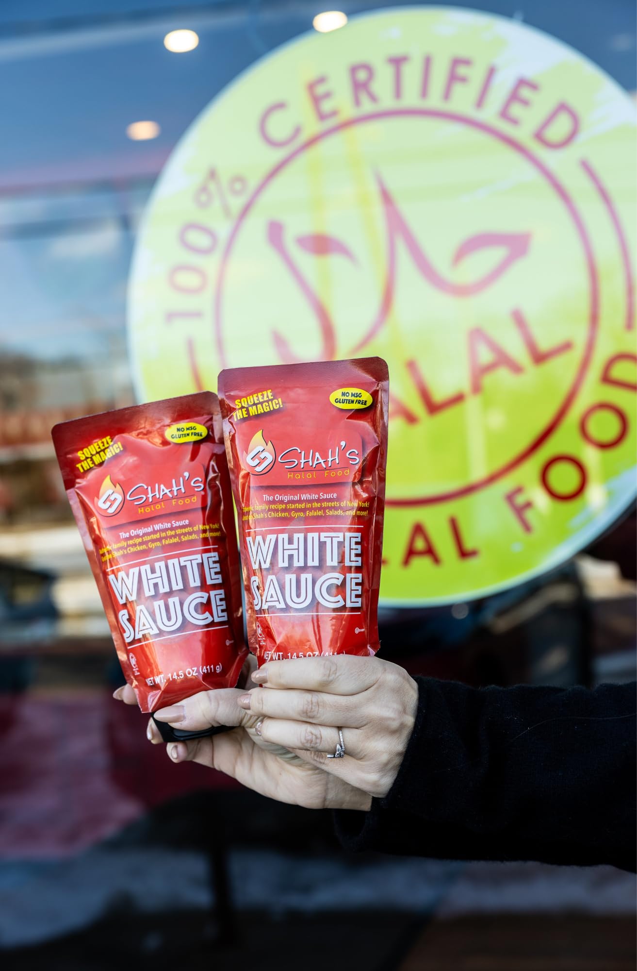 SHAH'S HALAL FOOD White Sauce on a fresh salad, adding a tangy, creamy touch.