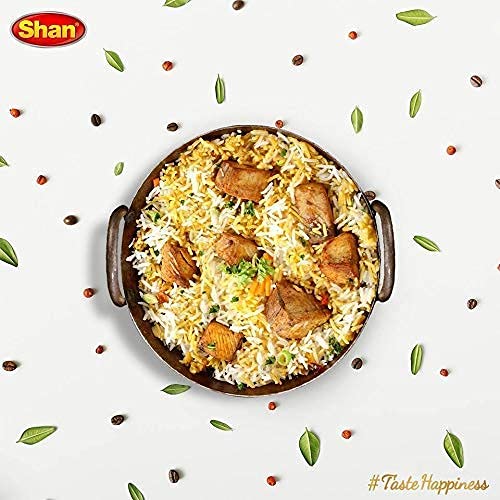 Shan Biryani Masala cooked biryani steaming bowl shows aromatic finish.