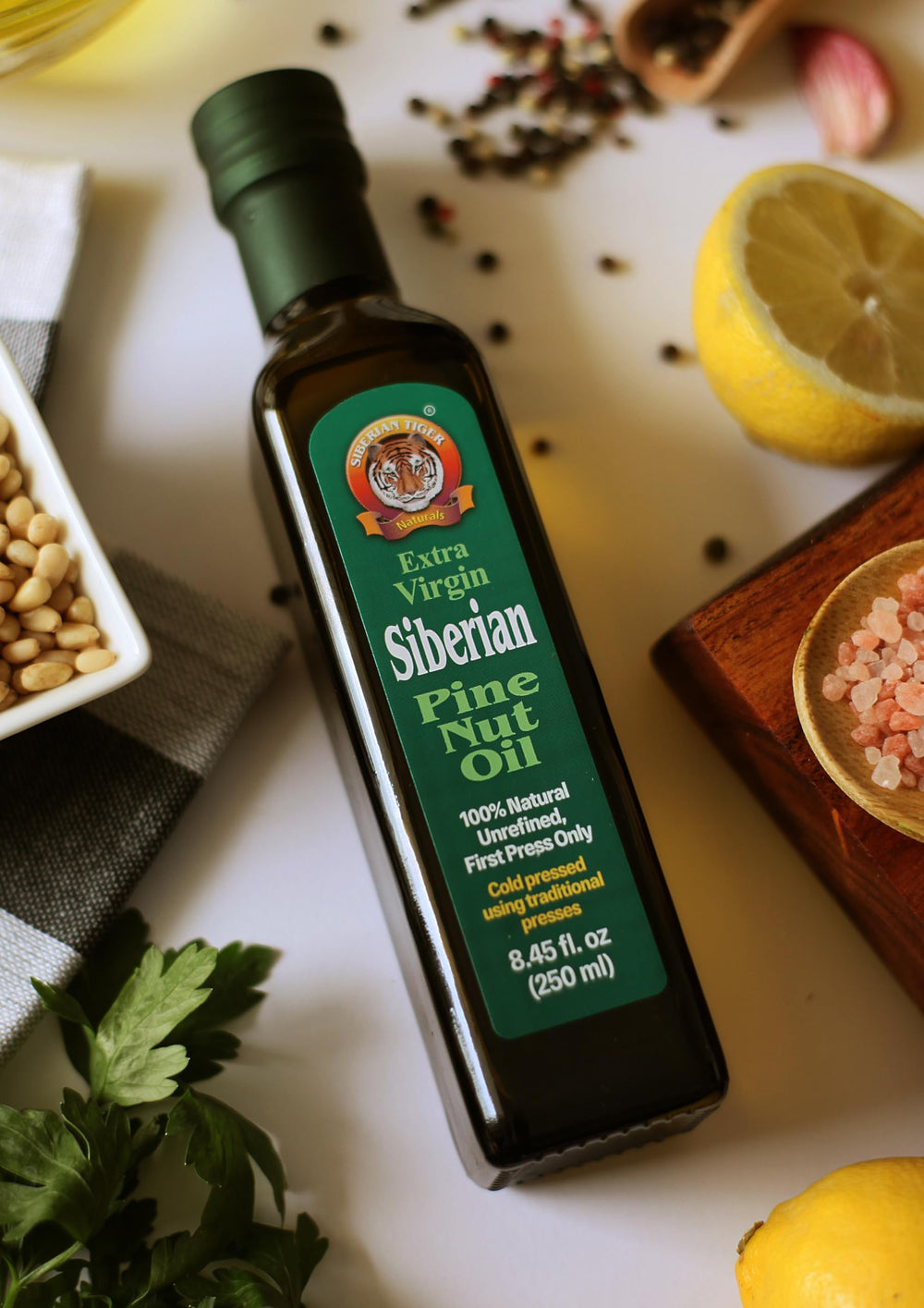 Siberian Tiger Naturals pine nut oil bottle on a rustic kitchen table