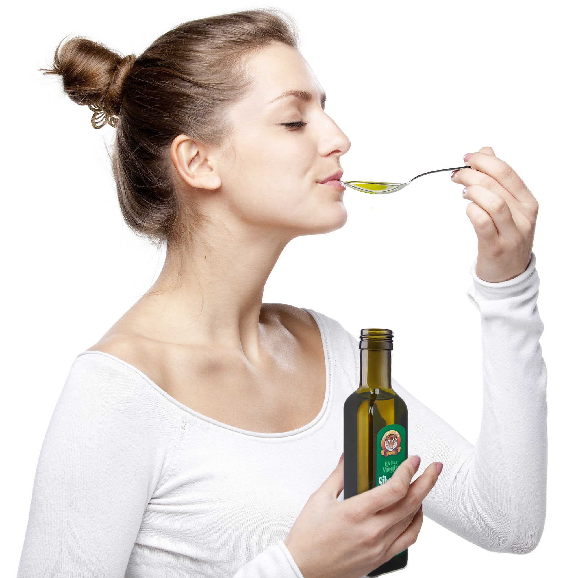 Siberian Tiger Naturals pine nut oil in measuring spoon with sunlit background