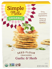 Simple Mills Cracker Seed Garlic Herb box on kitchen counter for quick snacking.