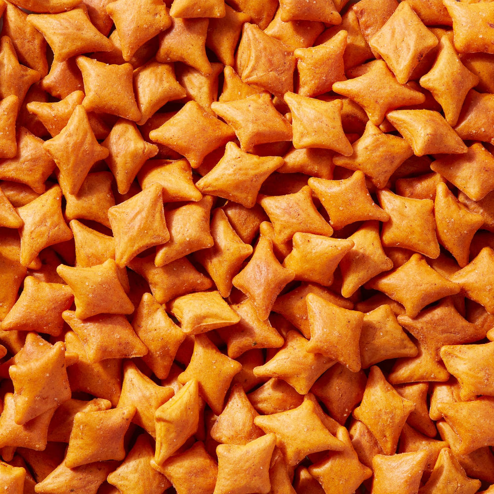 Close-up of Simple Mills cheddar crackers highlighting texture and gluten-free appeal for lunchboxes.