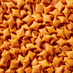 Close-up of Simple Mills cheddar crackers highlighting texture and gluten-free appeal for lunchboxes.