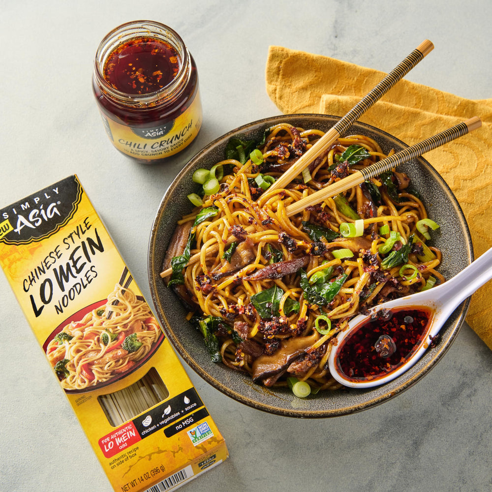 Simply Asia Chili Crunch Sauce with dumplings as a savory topper.