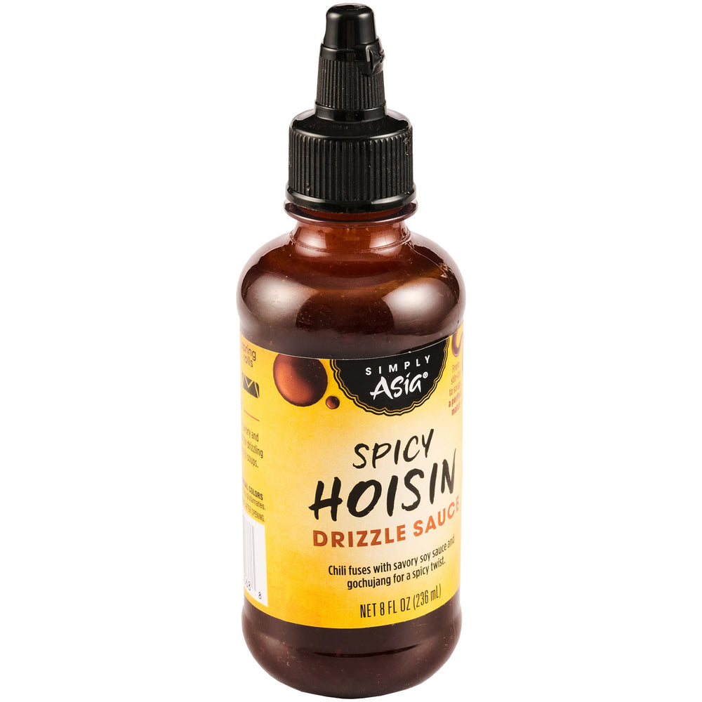 Simply Asia Spicy Hoisin Drizzle bottle pouring over noodles for quick flavor boost