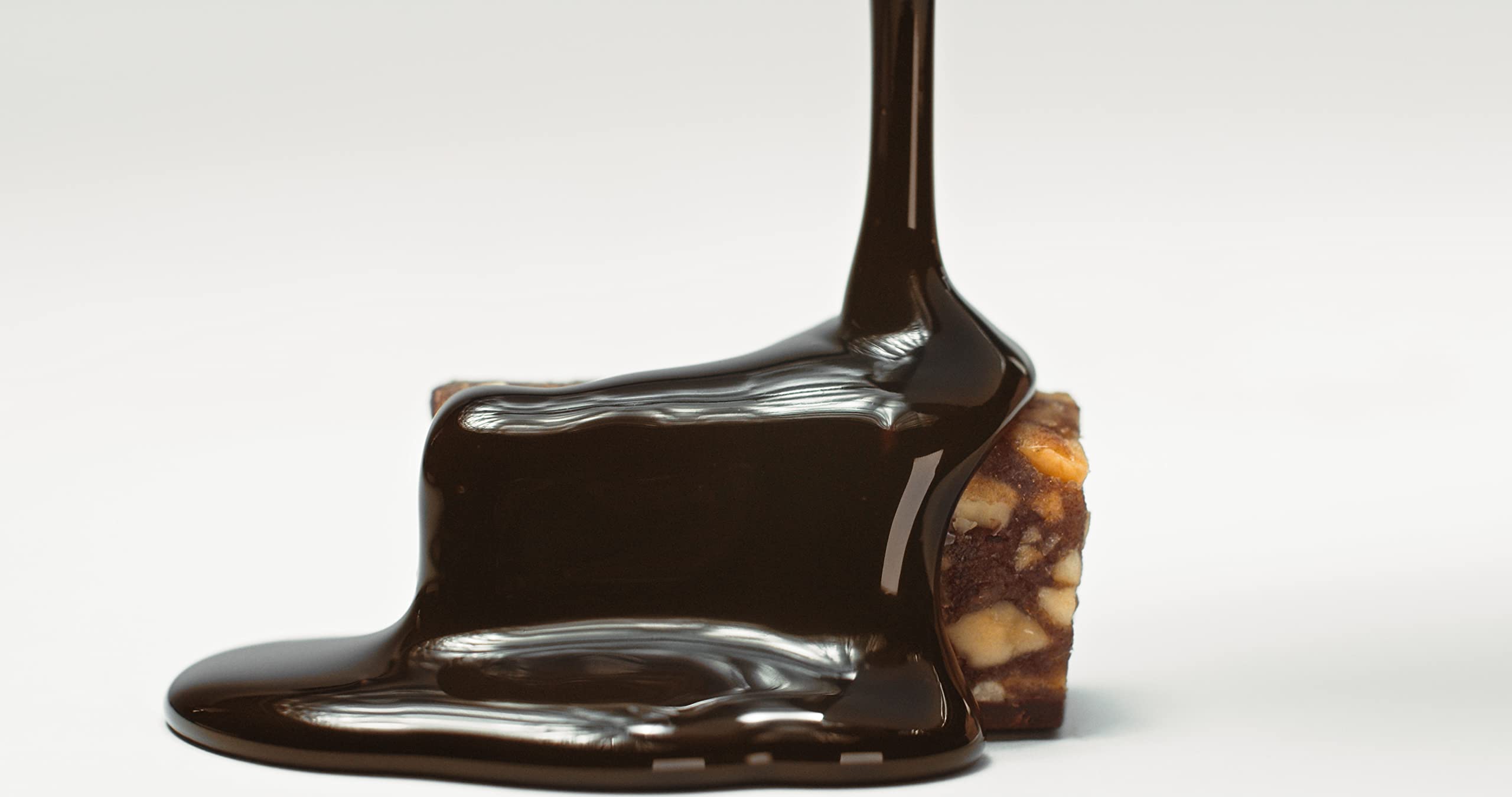 Simply Gum Salted Peanut Dark Chocolate Date Bars held in hand look inviting and portable.