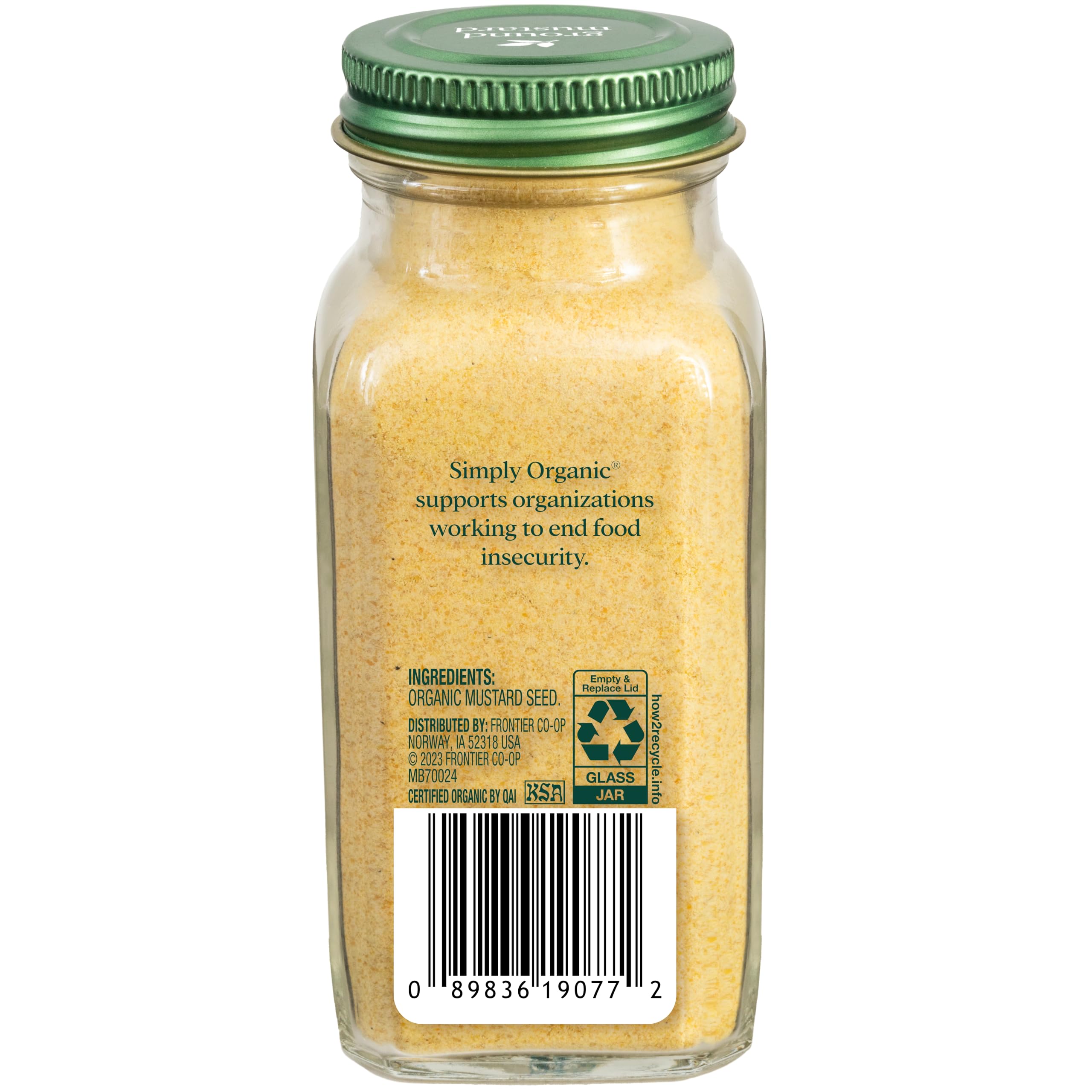 Simply Organic ground mustard seeds spoon close-up emphasizes tangy kick for curries