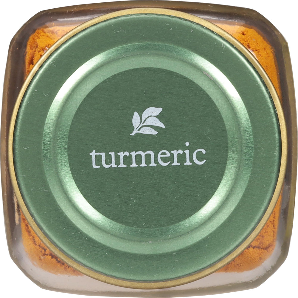 Golden turmeric powder dusting over a simmering rice dish for color and warmth.