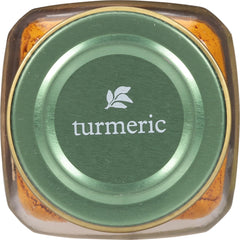 Golden turmeric powder dusting over a simmering rice dish for color and warmth.
