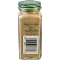 Pouring Simply Organic Umami Blend into a pan to enhance flavor and aroma.