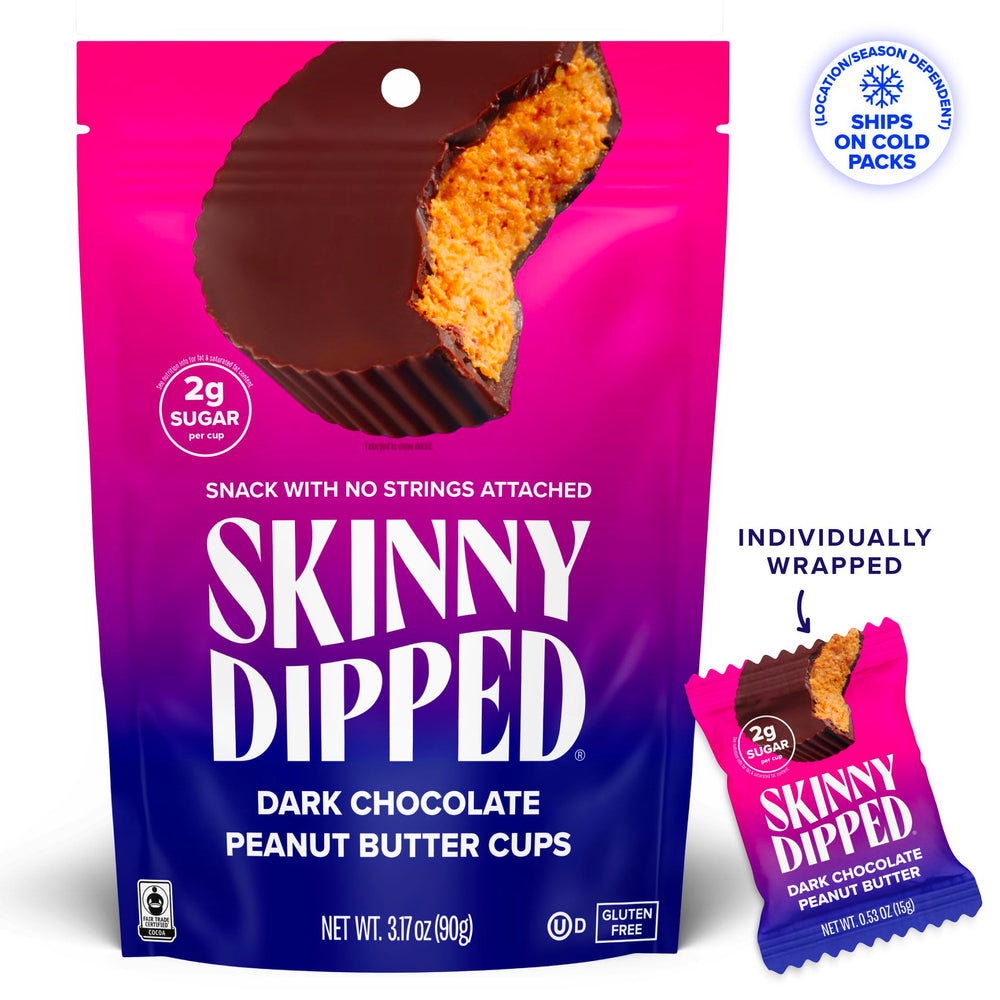 Close-up of glossy dark chocolate shell around peanut butter center.