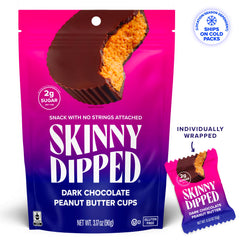 Close-up of glossy dark chocolate shell around peanut butter center.