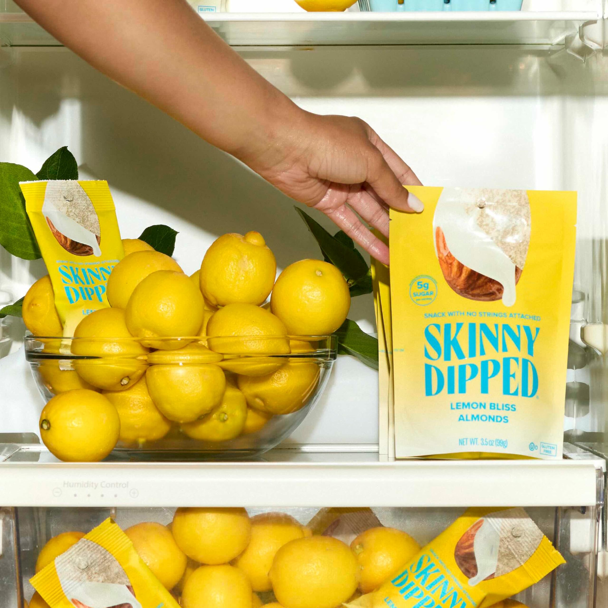 SkinnyDipped Lemon Bliss Almonds bag open for on-the-go snacking