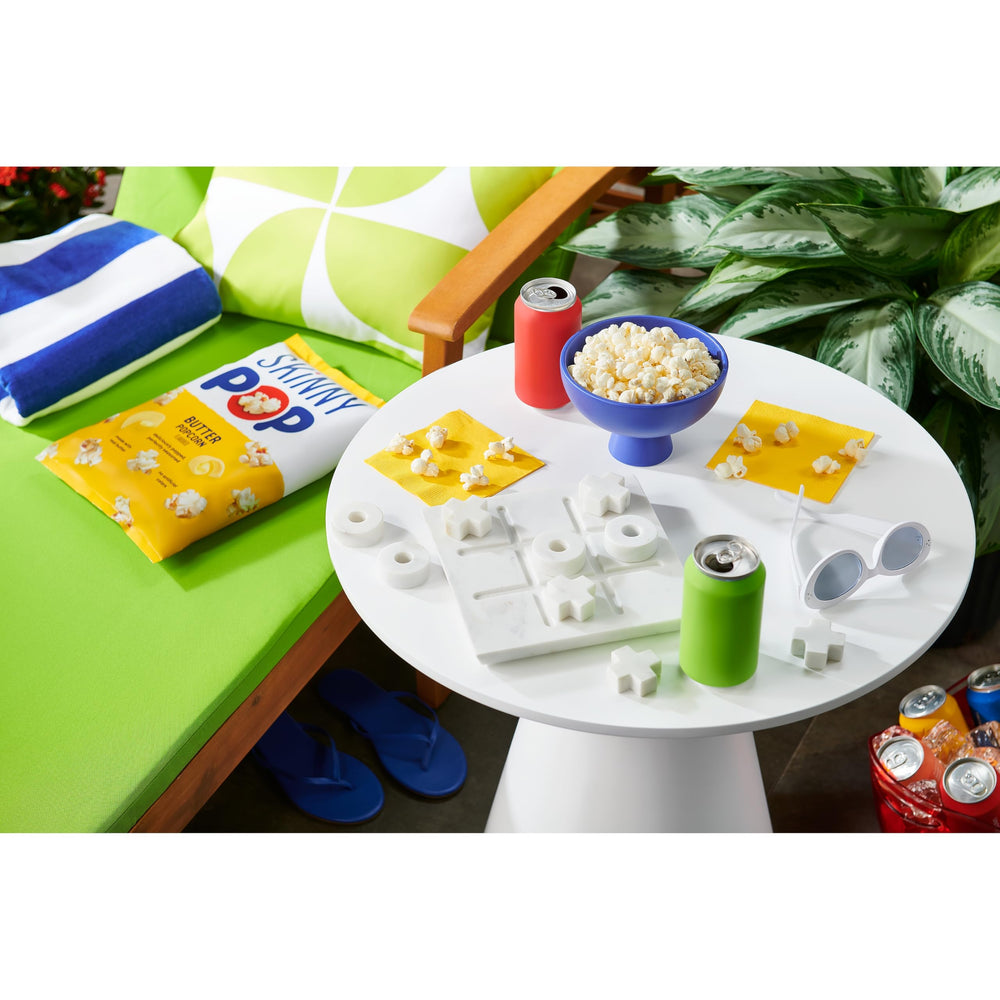 SkinnyPop Butter Popcorn on a coffee table during movie night.