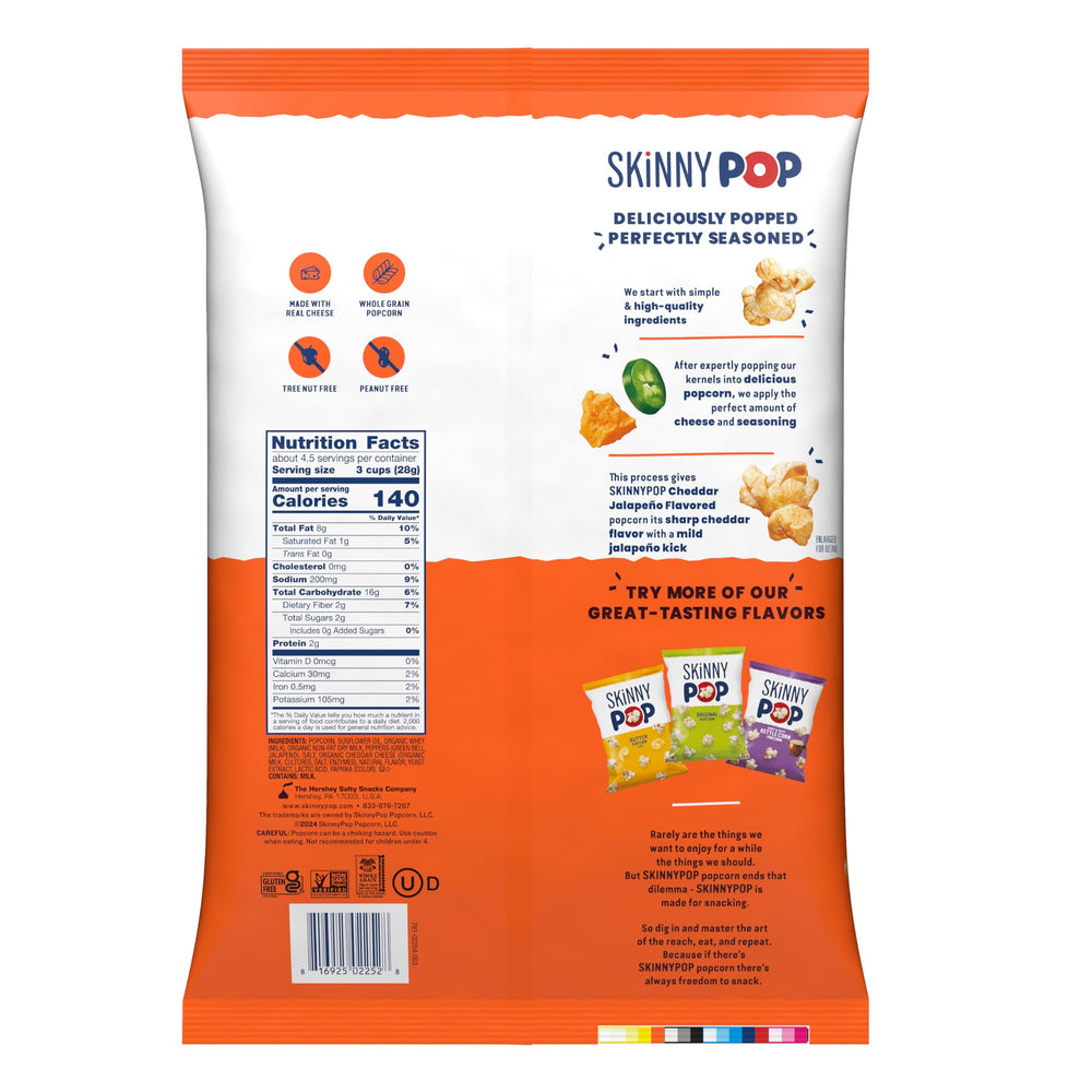 SkinnyPop Cheddar Jalapeno popcorn close-up shows cheesy specks and crunchy texture