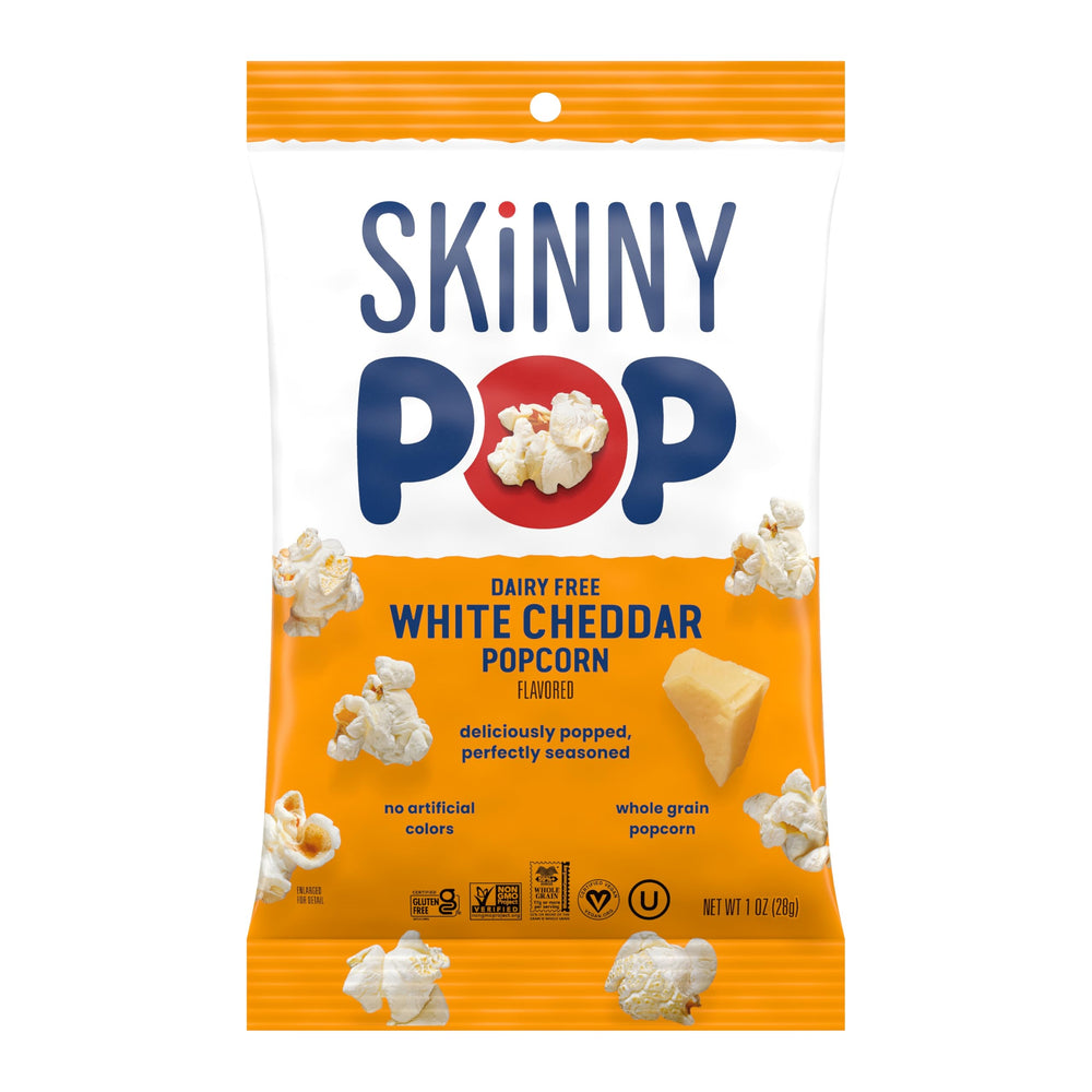 SkinnyPop on-the-go snack pack held during commute.