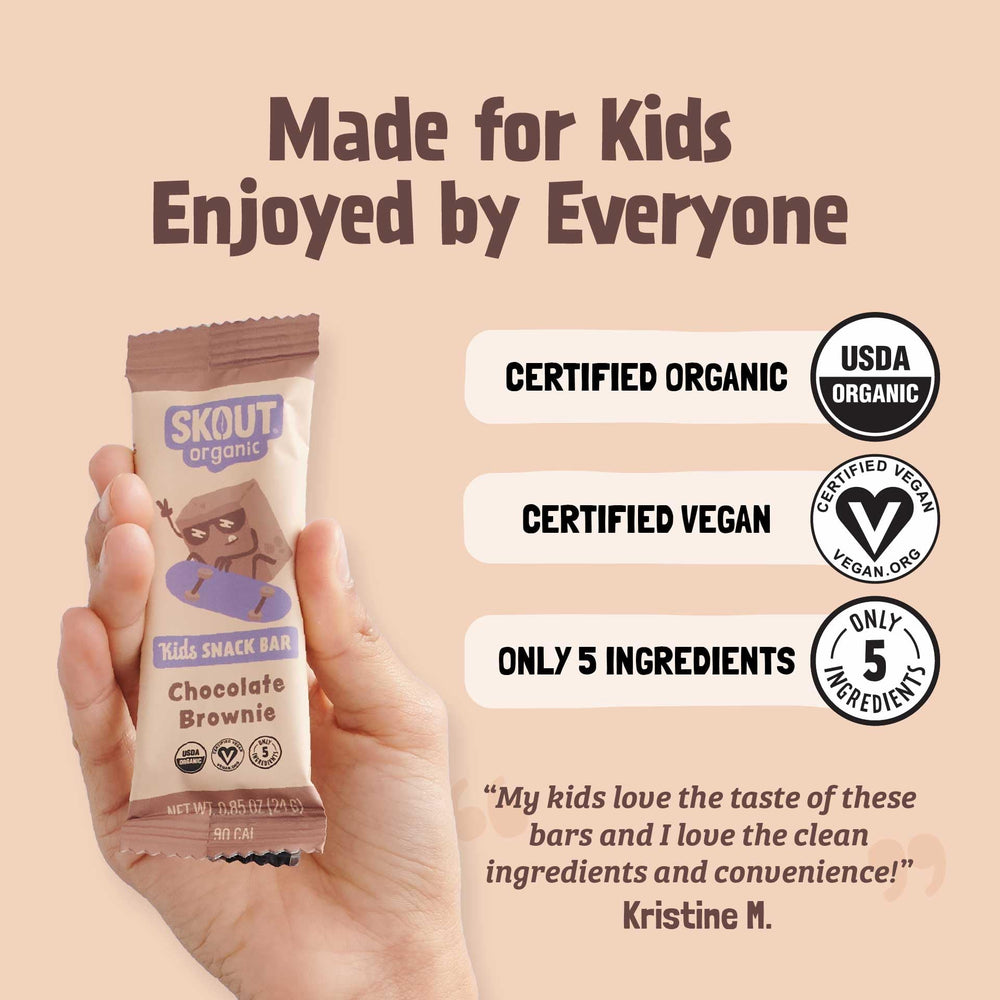 Joyful kid enjoying Skout brownie bar, a tasty school snack.